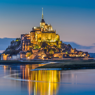 Beautiful view of famous Le Mont Saint-Michel tidal island in beautiful twilight during blue hour at dusk, Normandy, northern France