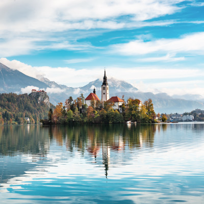 Church of Assumption in Lake Bled, Slovenia with blue sky and clouds in the autumn