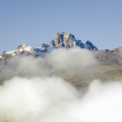 Aerial of Mount Kenya, Africa with snow and white puffy clouds in January