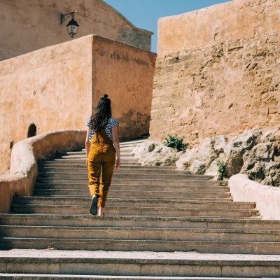 Girl explores ancient walled fortress known as the Kasbah des Oudayas in Morocco