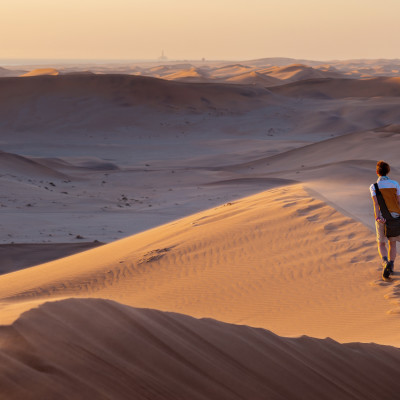 Tourist walking on the scenic dunes of Sossusvlei, Namib desert, Namib Naukluft National Park, Namibia, Africa