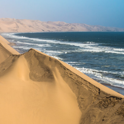 Atlantic coast of Walvis Bay, Namibia. Ocean surf with foamy waves