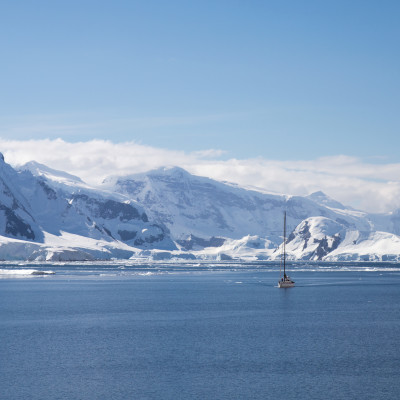 A sailing ship sails through the neumayer channel, Antarctica