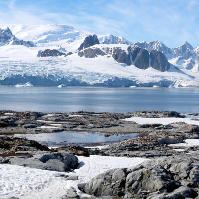 Antarctica water and snow-covered mountains with ship in background