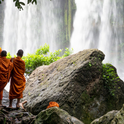 Group of young buddhist monks enjoying the view of Kulen Waterfall in Cambodia, Asia