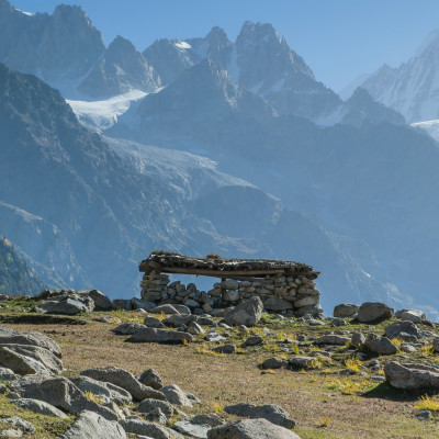 Local settlements in a vast meadow in autumn with glaciers and high mountains in the background, Nepal, Asia