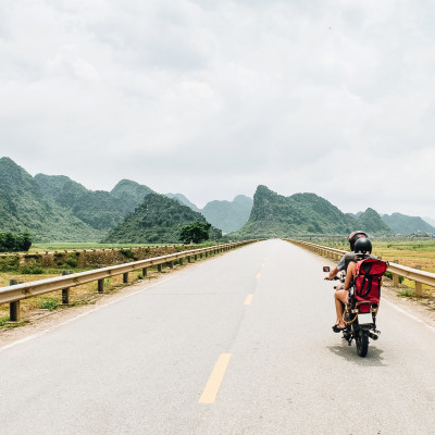 Young traveler couple making a adventure journey trip with a vintage motorcycle in Vietnam, Asia