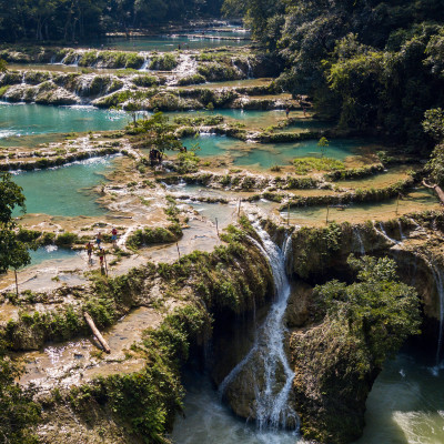 Aerial drone view of the turquoise pools and limestone bridges surrounded by the jungle in Semuc Champey, Guatemala, Central America