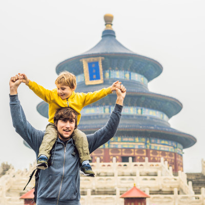 Enchanting Travels China Tours Dad and son travelers in the Temple of Heaven in Beijing. One of the main attractions of Beijing.