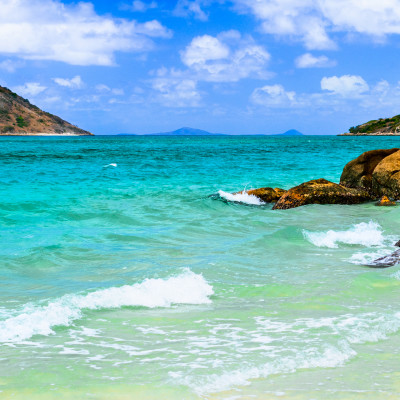 Enchanting Travels -Clear blue waters lapping on coastal rocks at Blue Lagoon on Lizard Island, Queensland