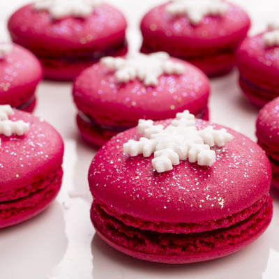 Enchanting Travels France Tours Christmas red macarons with snowflakes on top