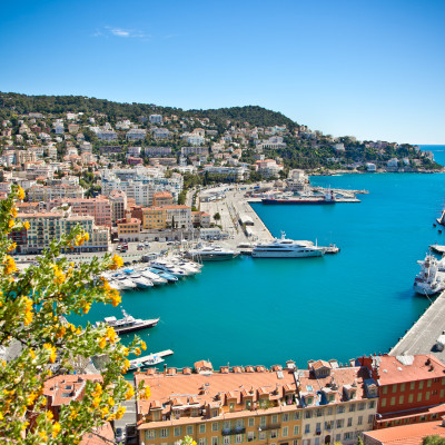 Enchanting Travels France Tours Panoramic view of Nice harbour with blue sky, France