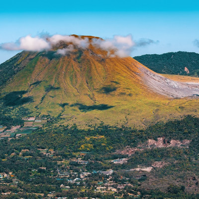 Enchanting Travels Indonesia Tours View from Mahawu volcano on the island of Sulawesi in Indonesia has a tiny crater lake.