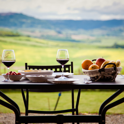 Enchanting-Travels - lunch with a view - table against beautiful landscape in Tuscany