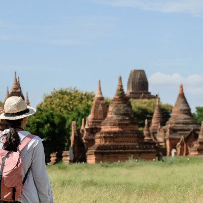 Young woman traveling backpacker with hat looking beautiful ancient temples, Bagan, Myanmar, Asia