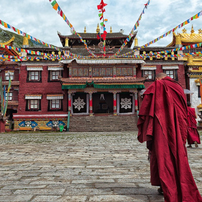 lama going towards the temple in Tibet