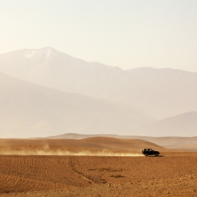 Vehicle driving through Agafay desert, Morocco