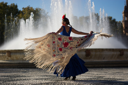 Beautiful woman dancing flamenco near the fountain