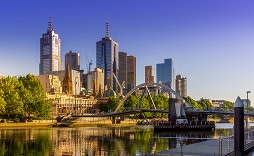 Enchanting Travels Australia Tours Panorama of Melbourne CBD with Skyscrapers, Evan Walker Bridge and Yarra River against clear sky