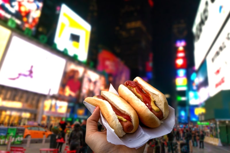 holding-two-hot-dogs-nyc