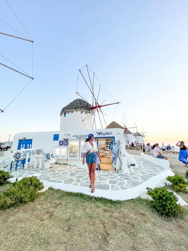woman-in-white-and-green-dress-standing-on-white-concrete-floor-during-daytime