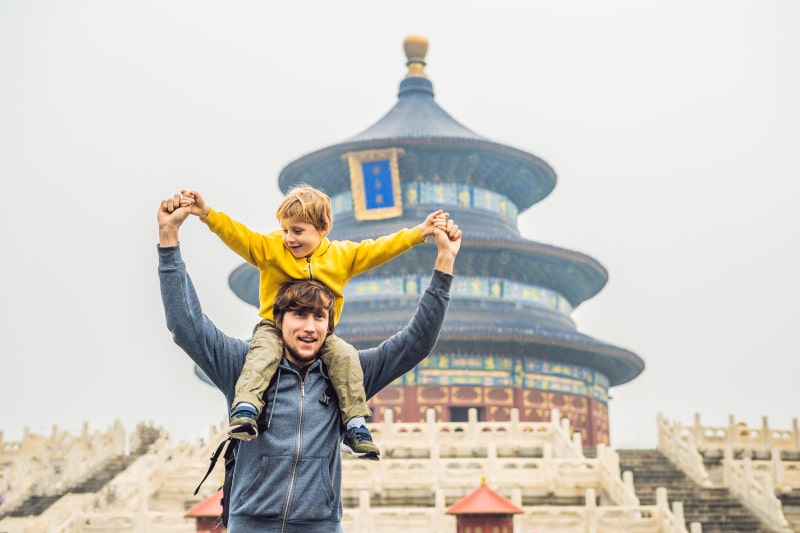 Enchanting Travels China Tours Dad and son travelers in the Temple of Heaven in Beijing. One of the main attractions of Beijing.