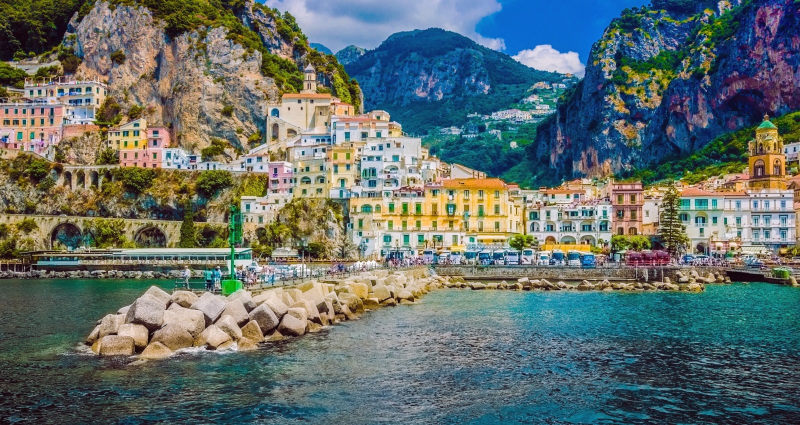 Enchanting Travels Italy Tours Wonderful Italy. The small haven of Amalfi village with a turquoise sea and colorful houses on the slopes of the coast