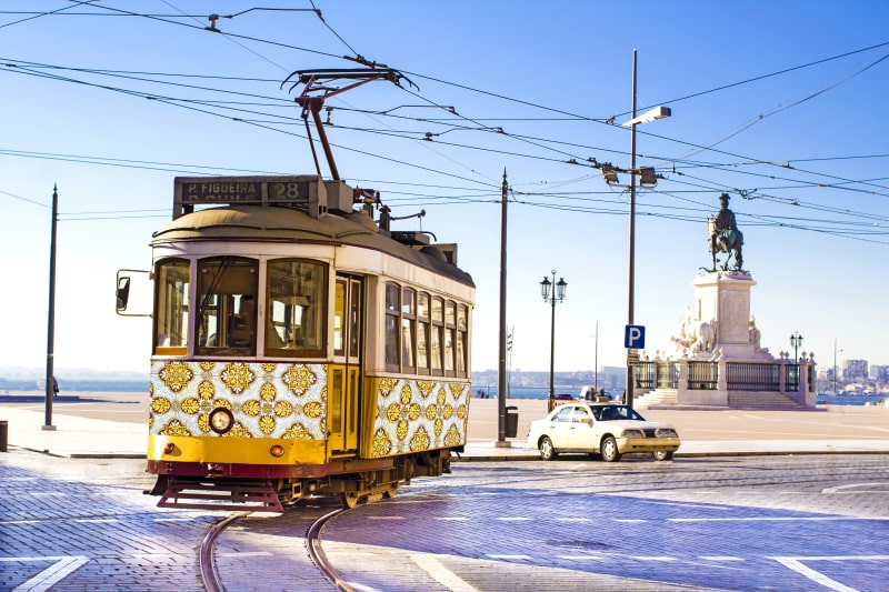 Vintage yellow tramway at the Commerce Square in Lisbon, Portugal