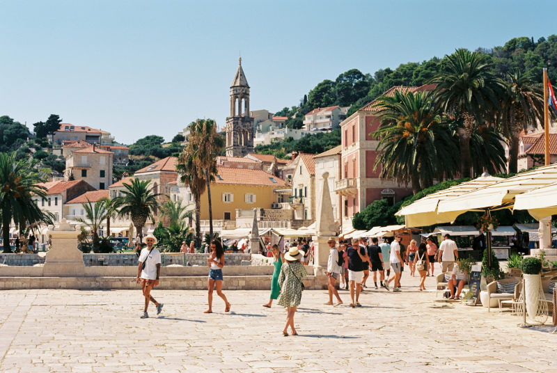 a-group-of-people-walking-around-a-town-square-croatia