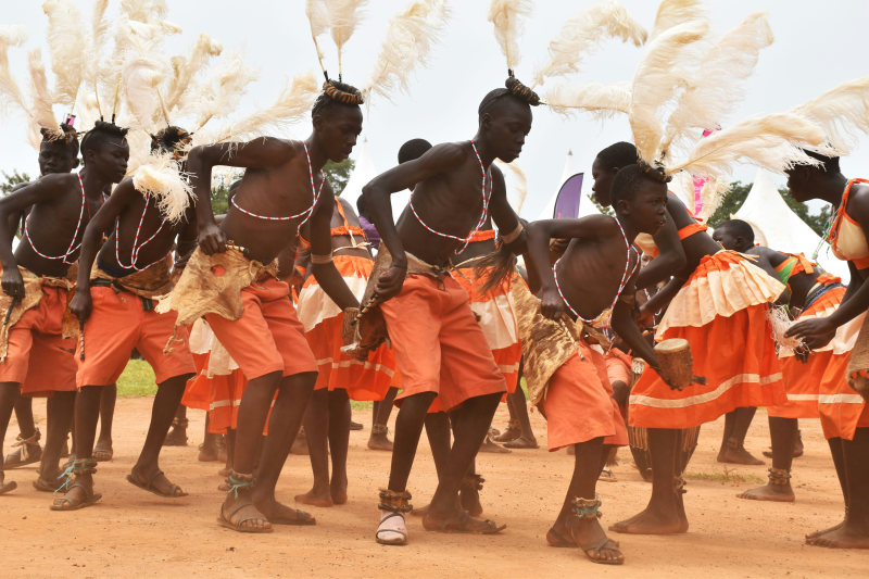 people-dancing-on-brown-soil-uganda