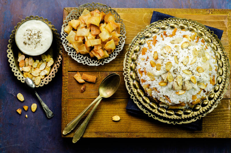 Arabic cuisine Jordanian Chicken Mansaf on copper plate