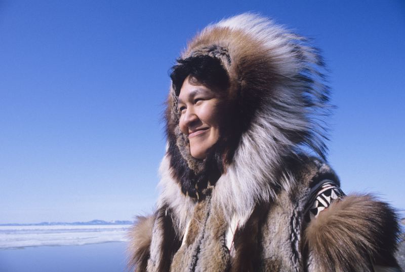 Smiling Eskimo woman wearing traditional clothing arctic