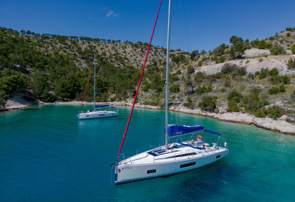 two sailing monohull yachts anchored