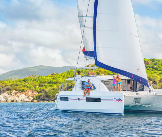 family on sailing catamaran in the BVI