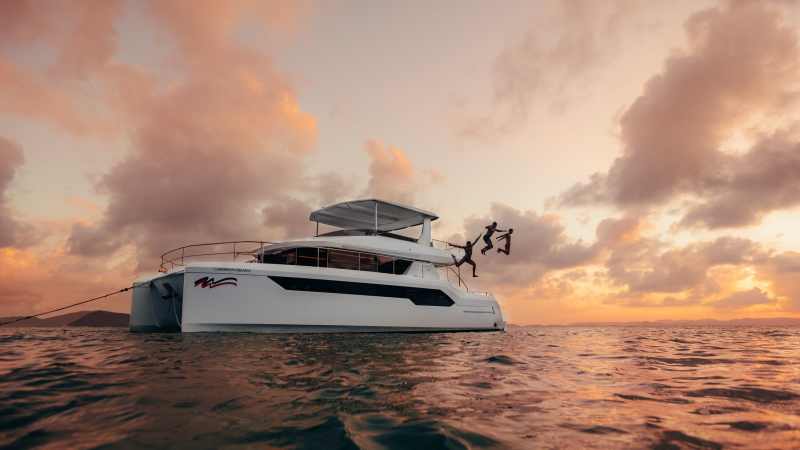 Charter guests jumping in to the ocean in the BVI from a Moorings 534PC