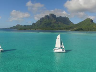 Two Moorings 4800 under sail with Bora Bora in the background