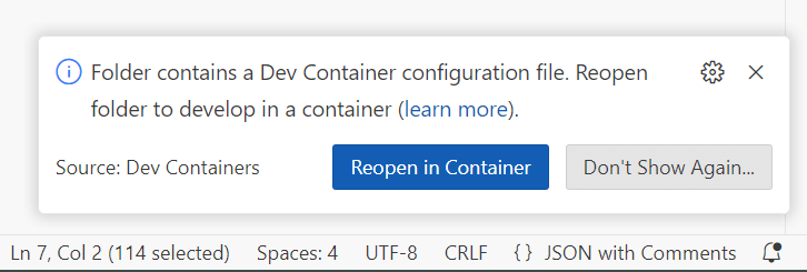 A Visual Studio Code popup saying "Folder contains a Dev Container configuration file. Reopen folder to develop in a container". The pop has two buttons: "Reopen in container" and "Don't show again"