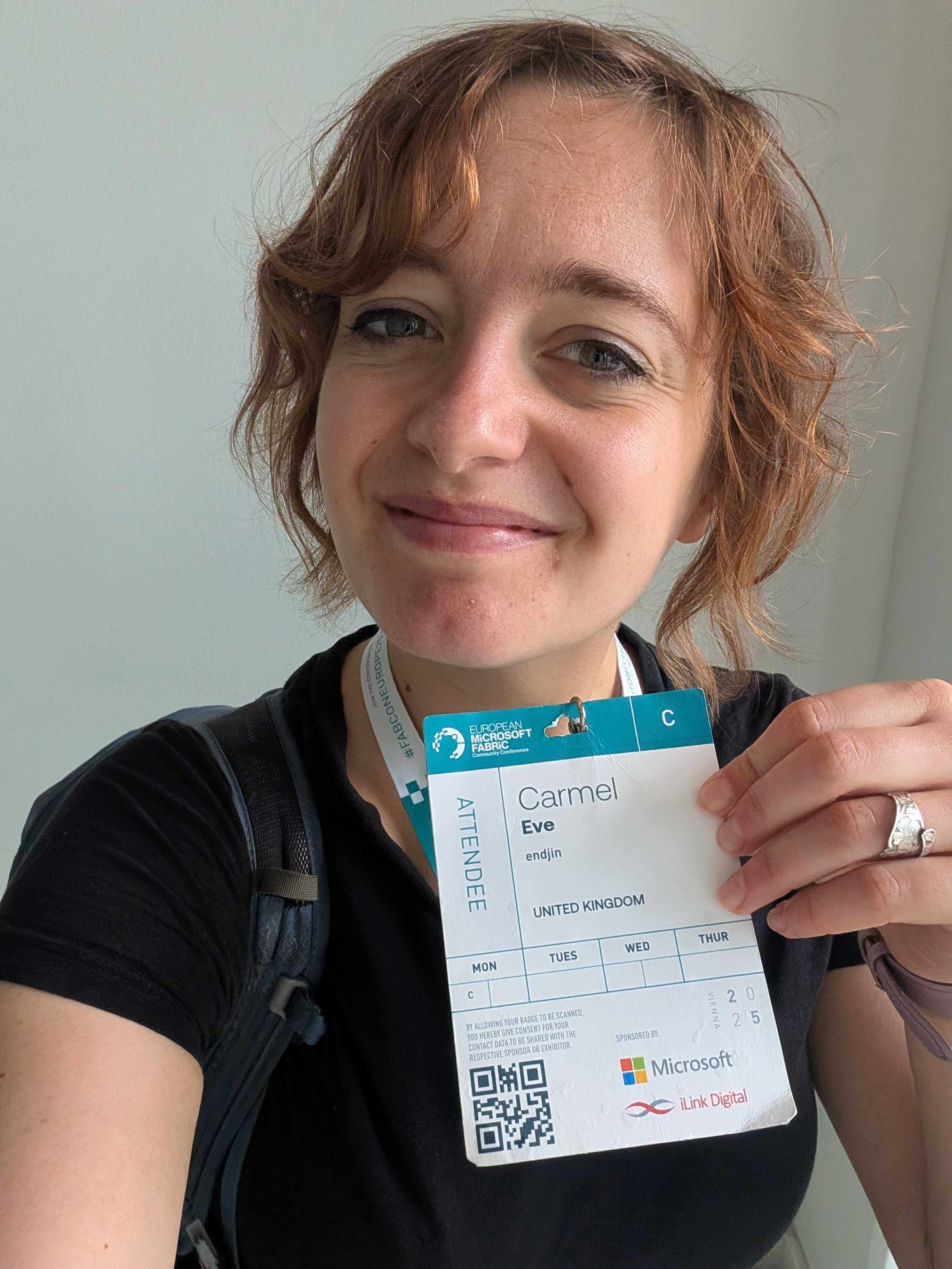 Me holding my conference pass.