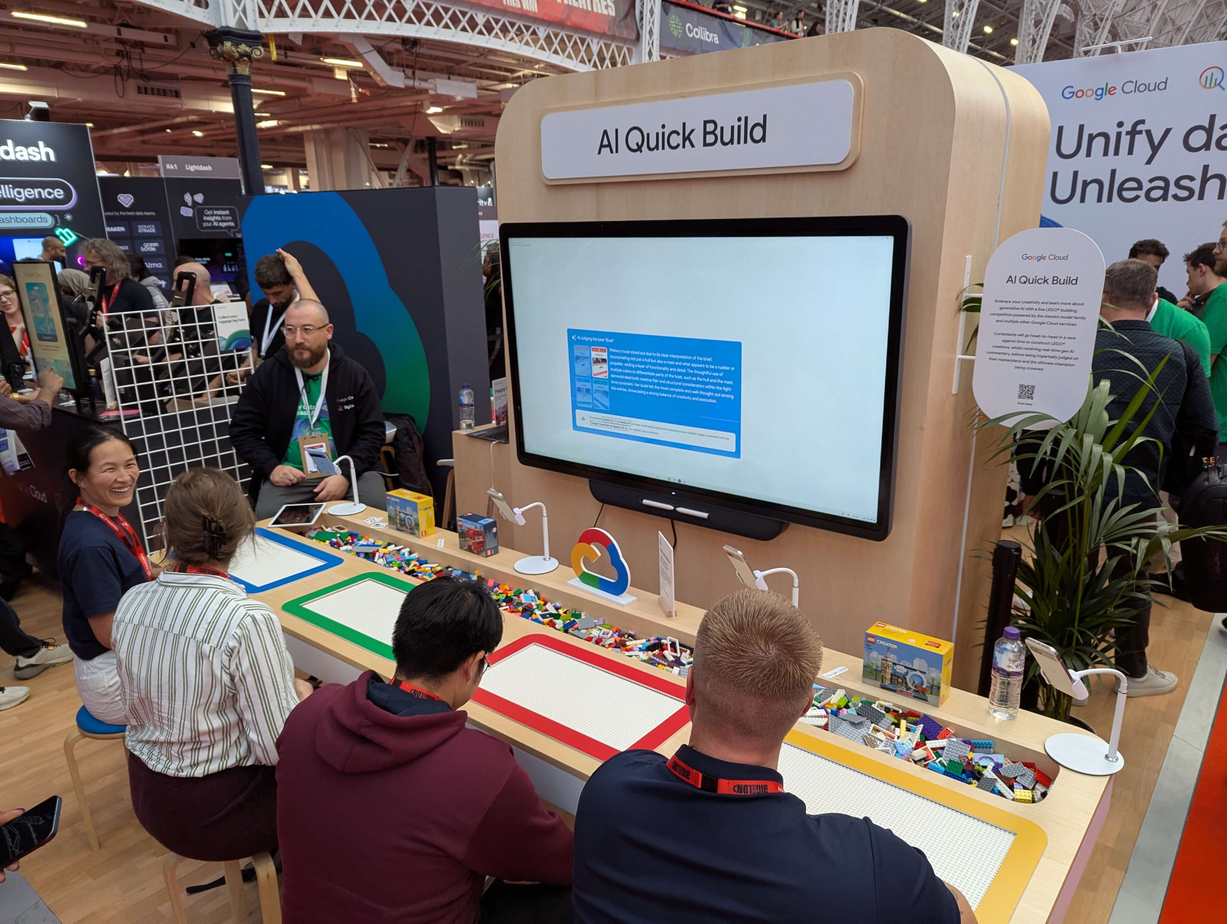 Picture of Google's stand and specifically 4 contestants ready to go head to head in the lego builders challenge judged by an AI