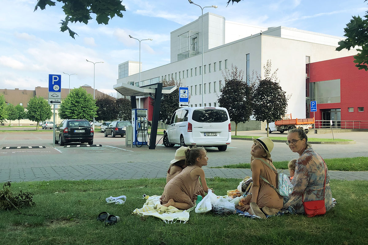 While the car was eating, the family could have a picnic as well