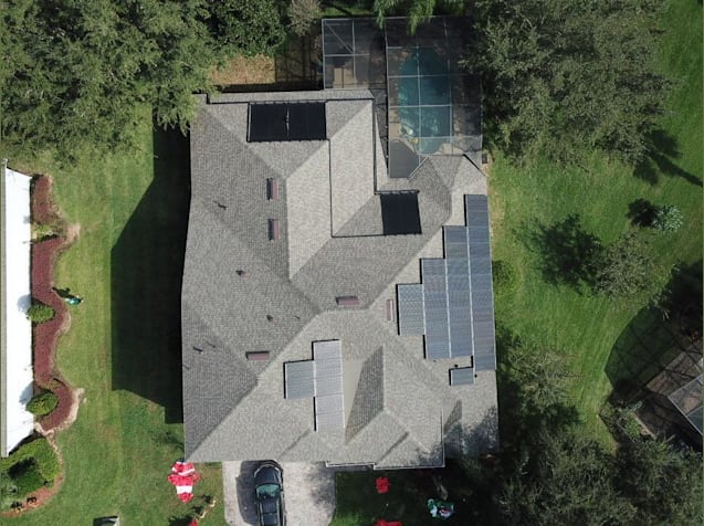 We installed this new roof, 11.52kW solar electric system, and a solar pool heating system on this Clermont home!