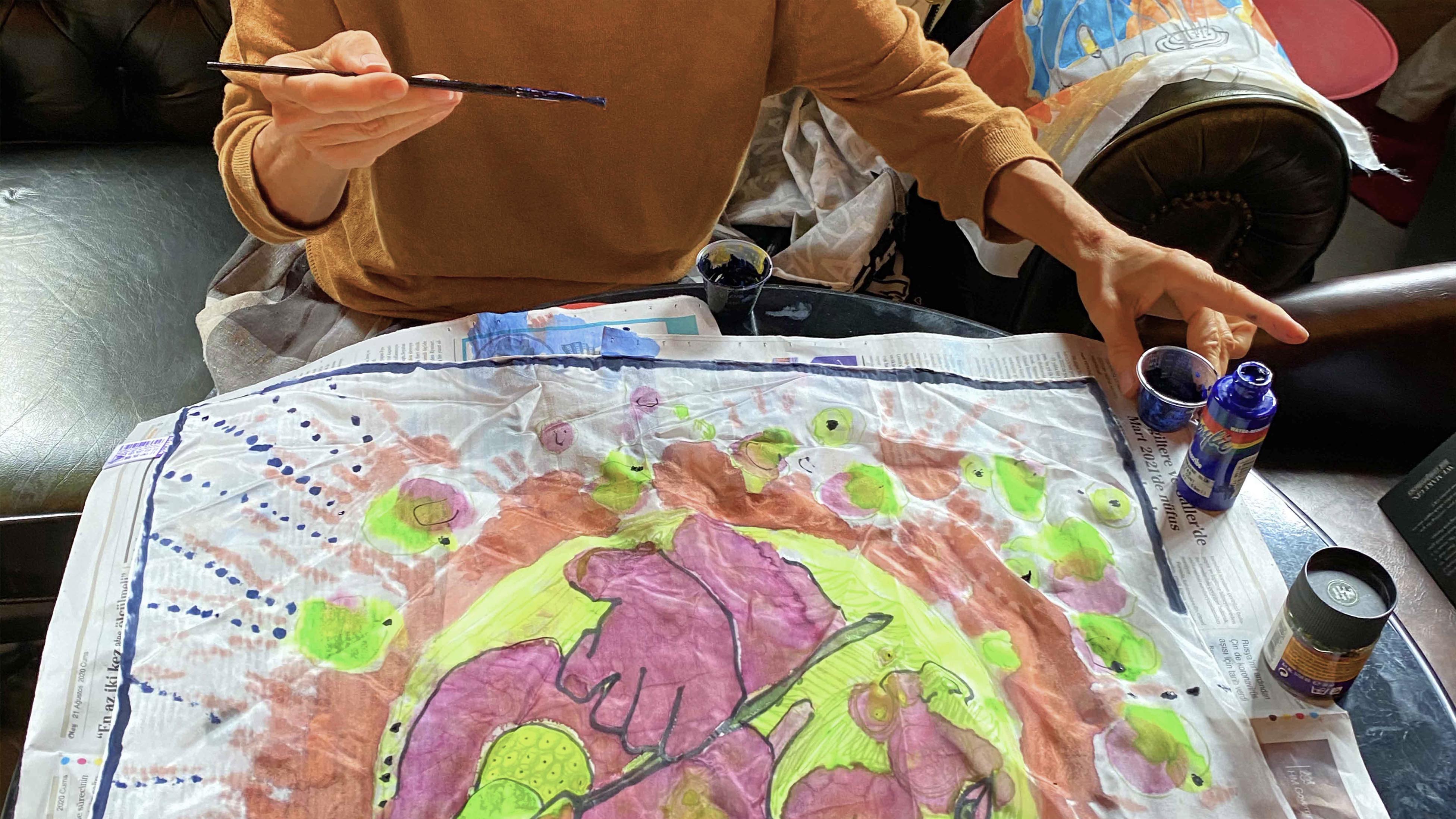 Person painting silk