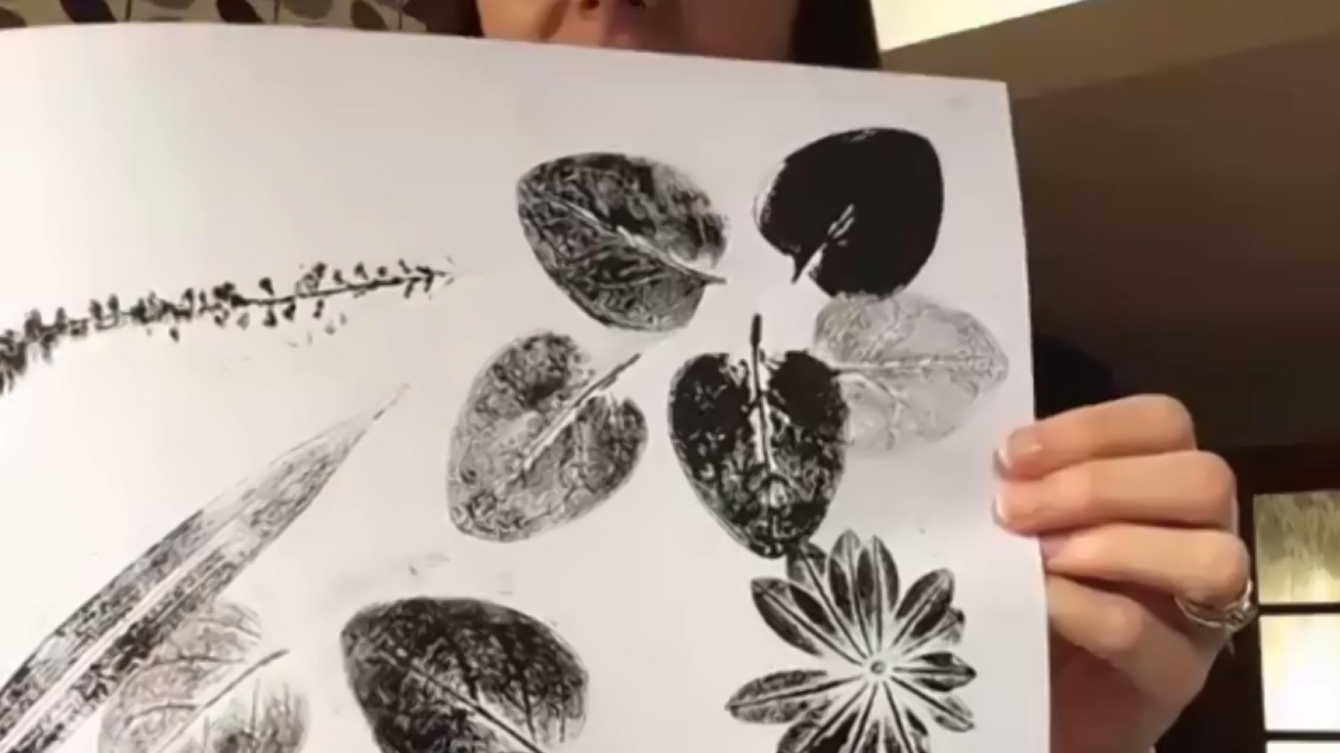 Woman holding prints of leaves