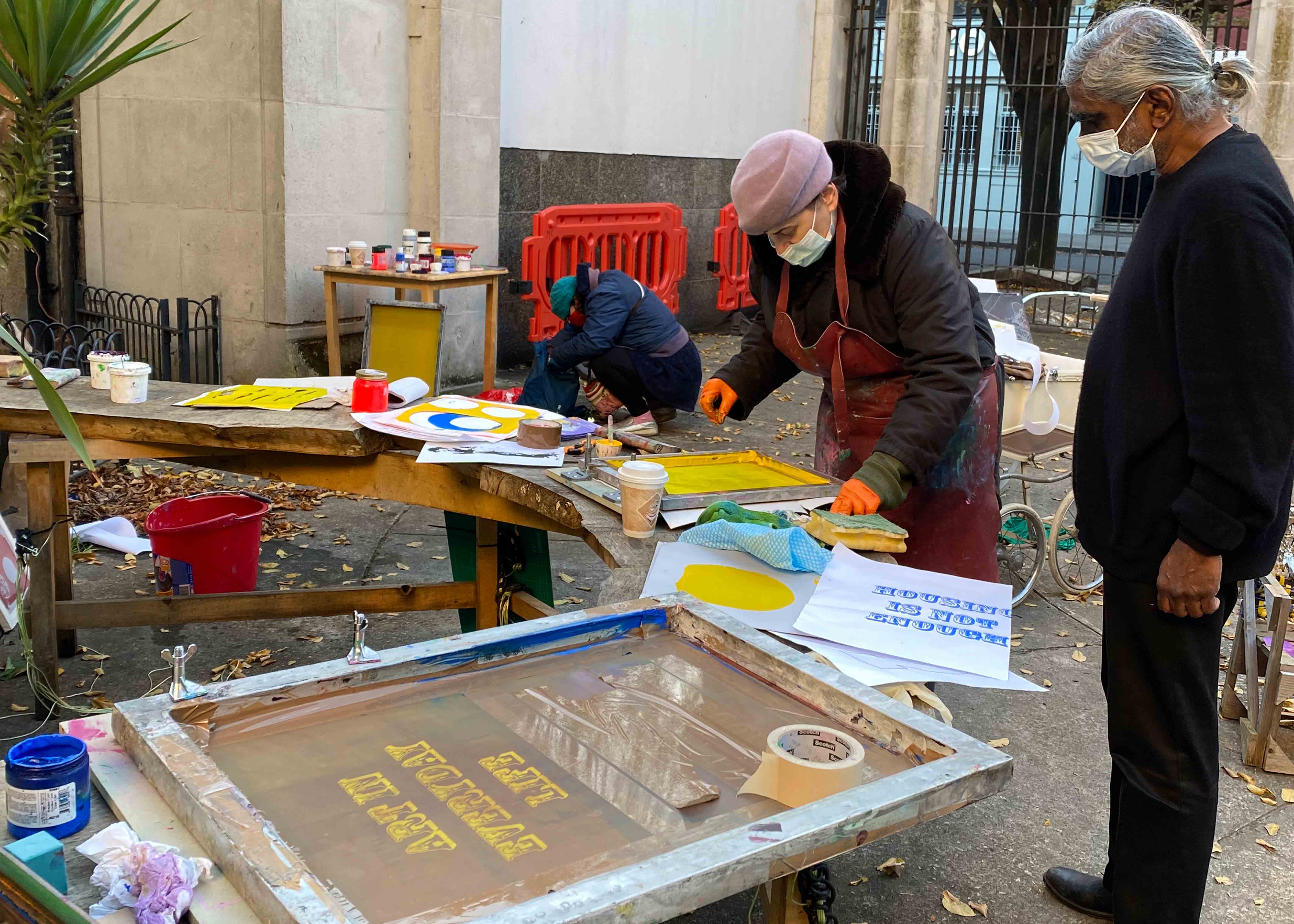 Three people printing outside