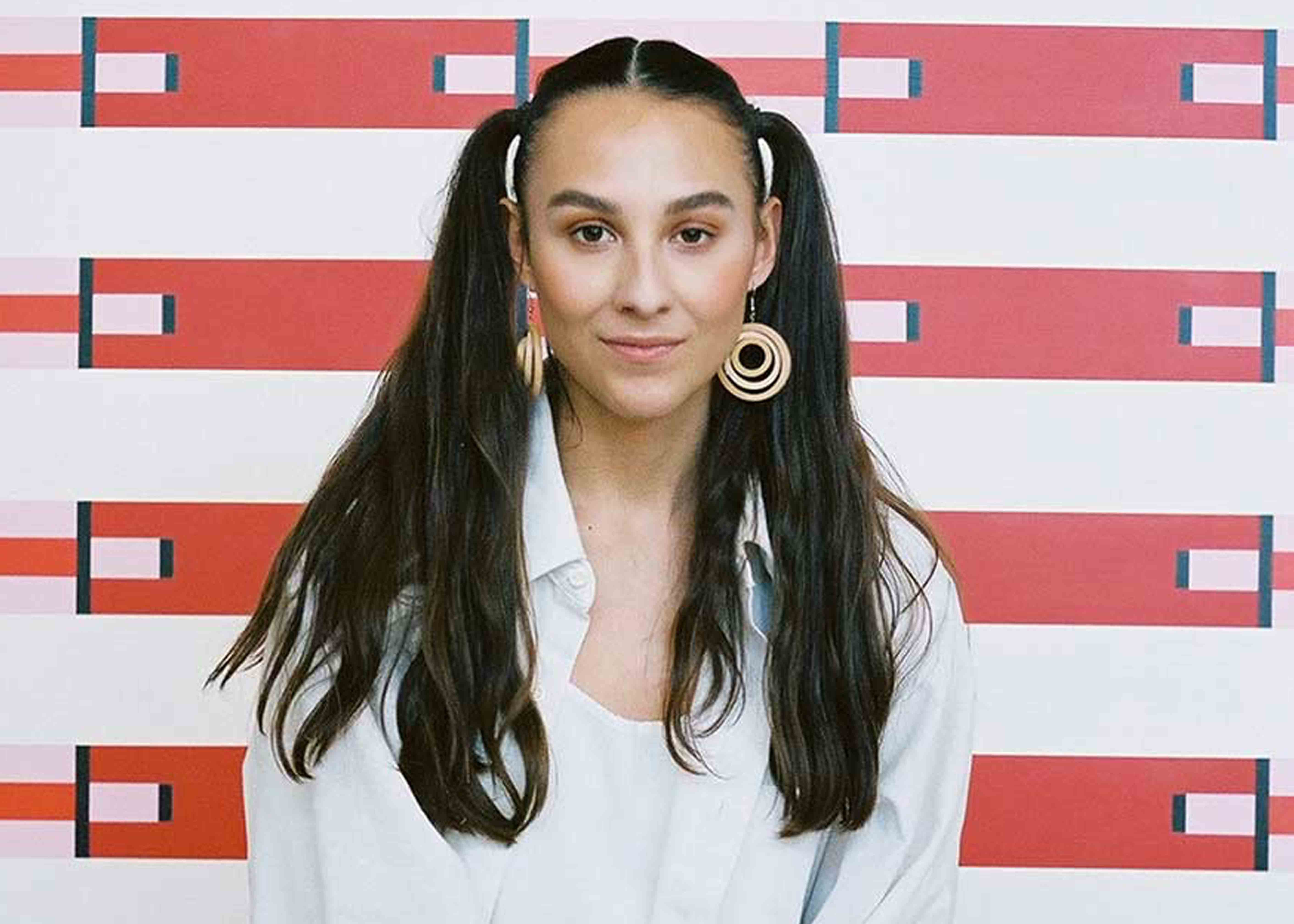 An artist in front of her work