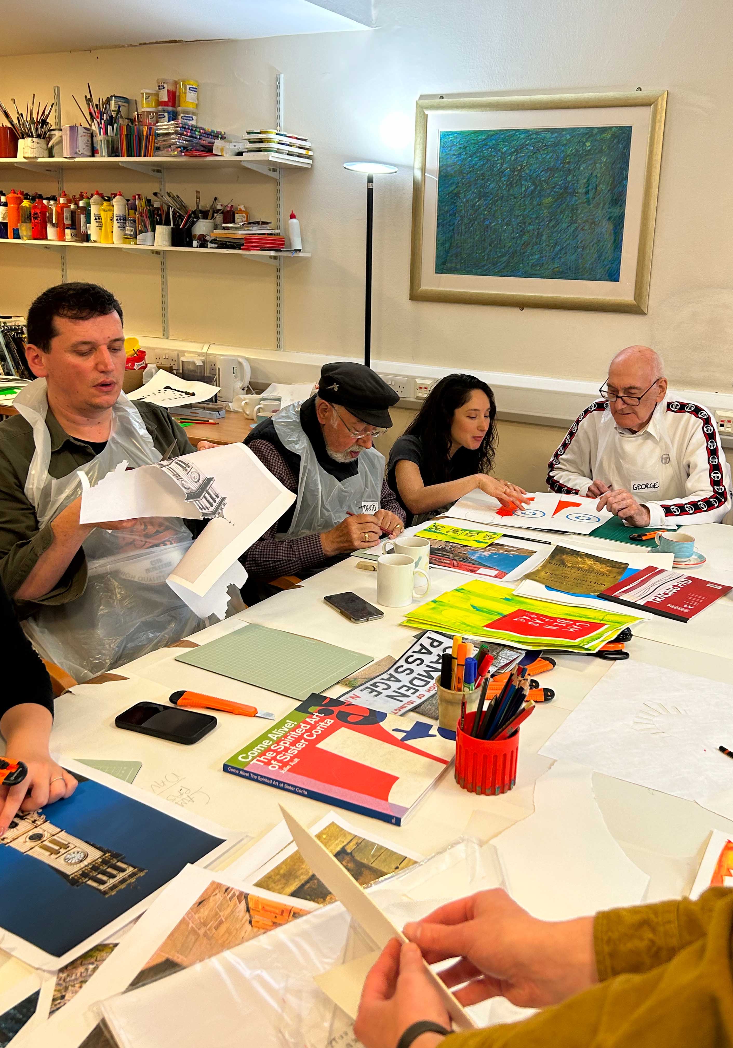 a group of people cutting out stencils