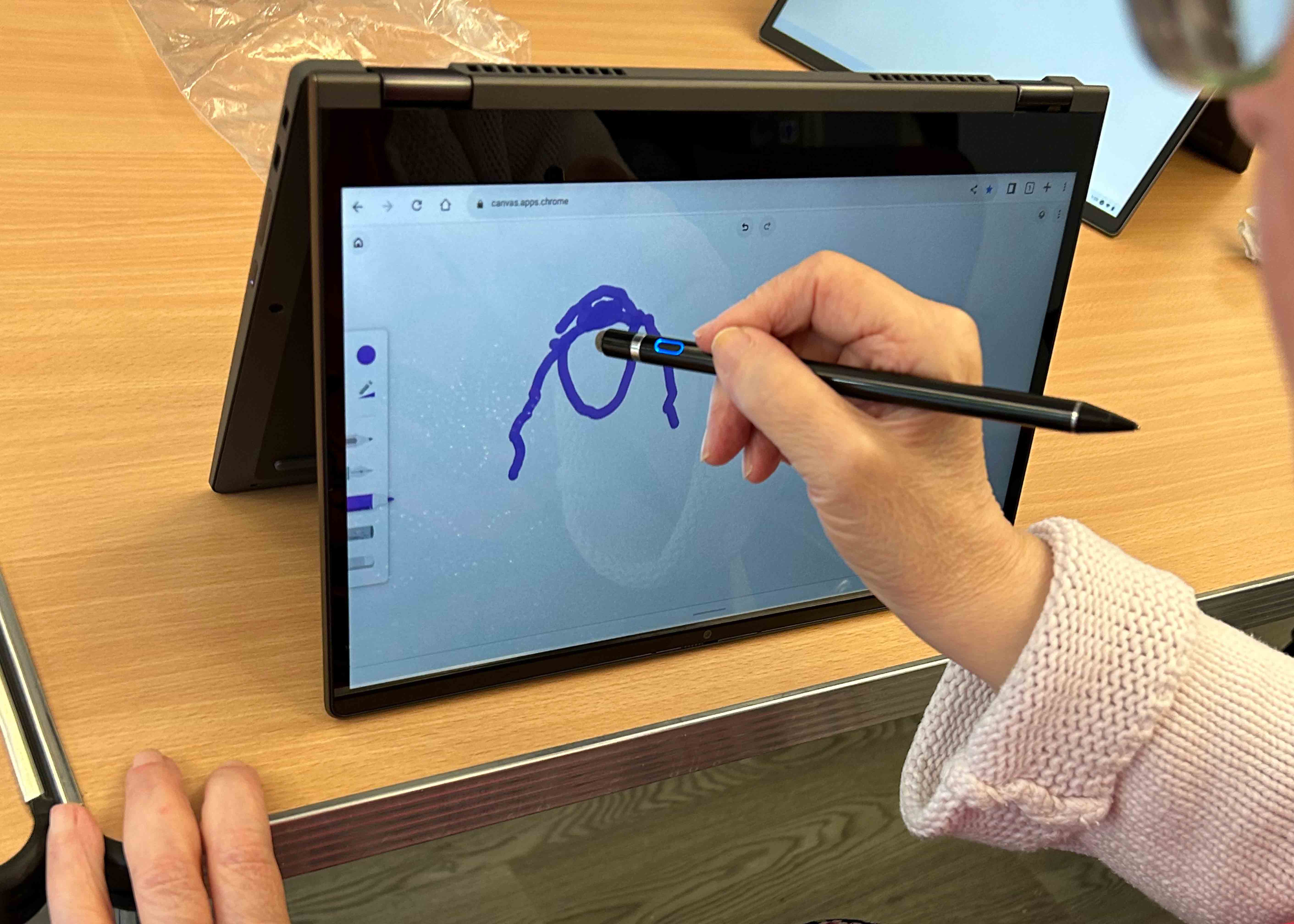 Person drawing on tablet