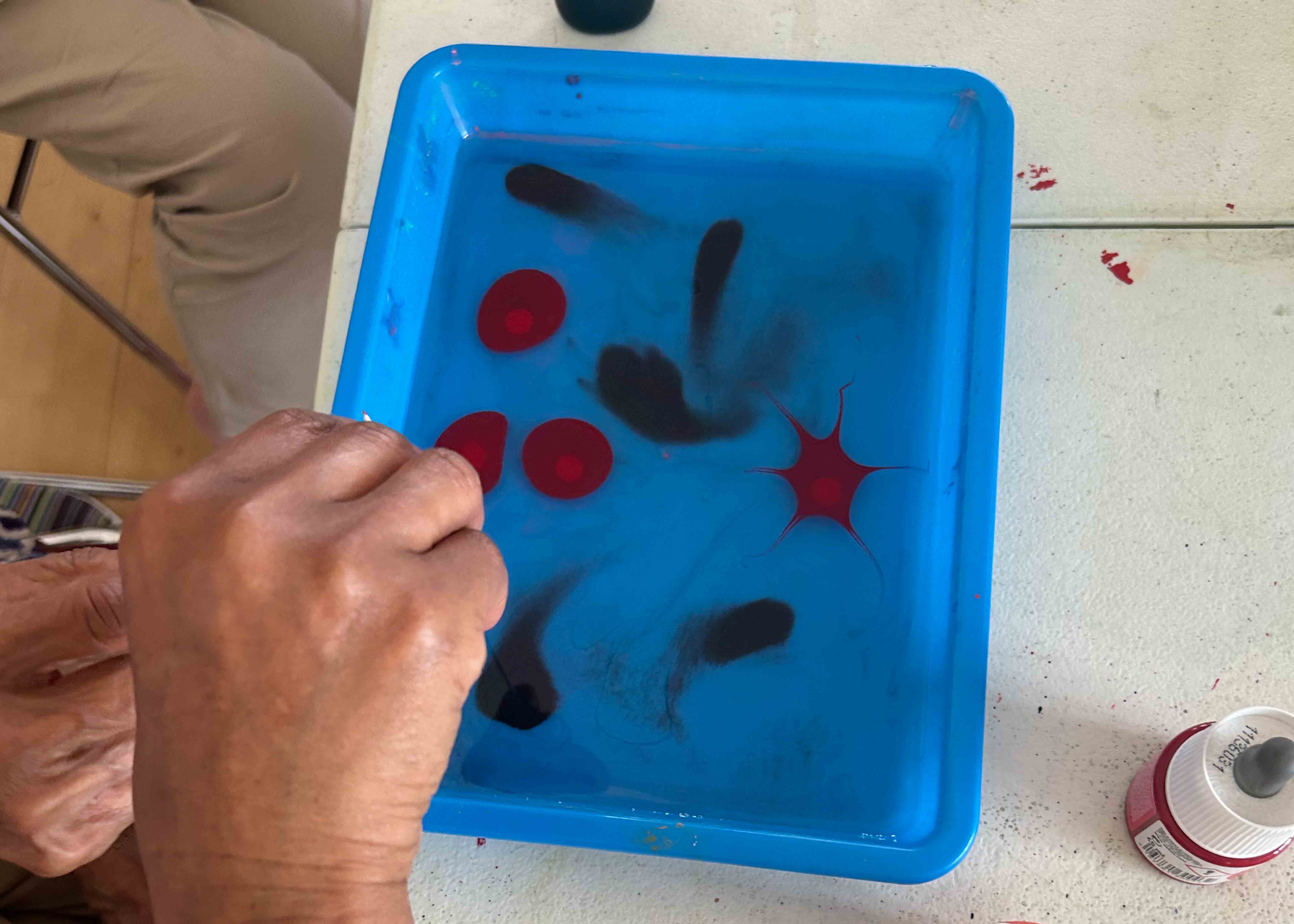 Person dropping ink into water