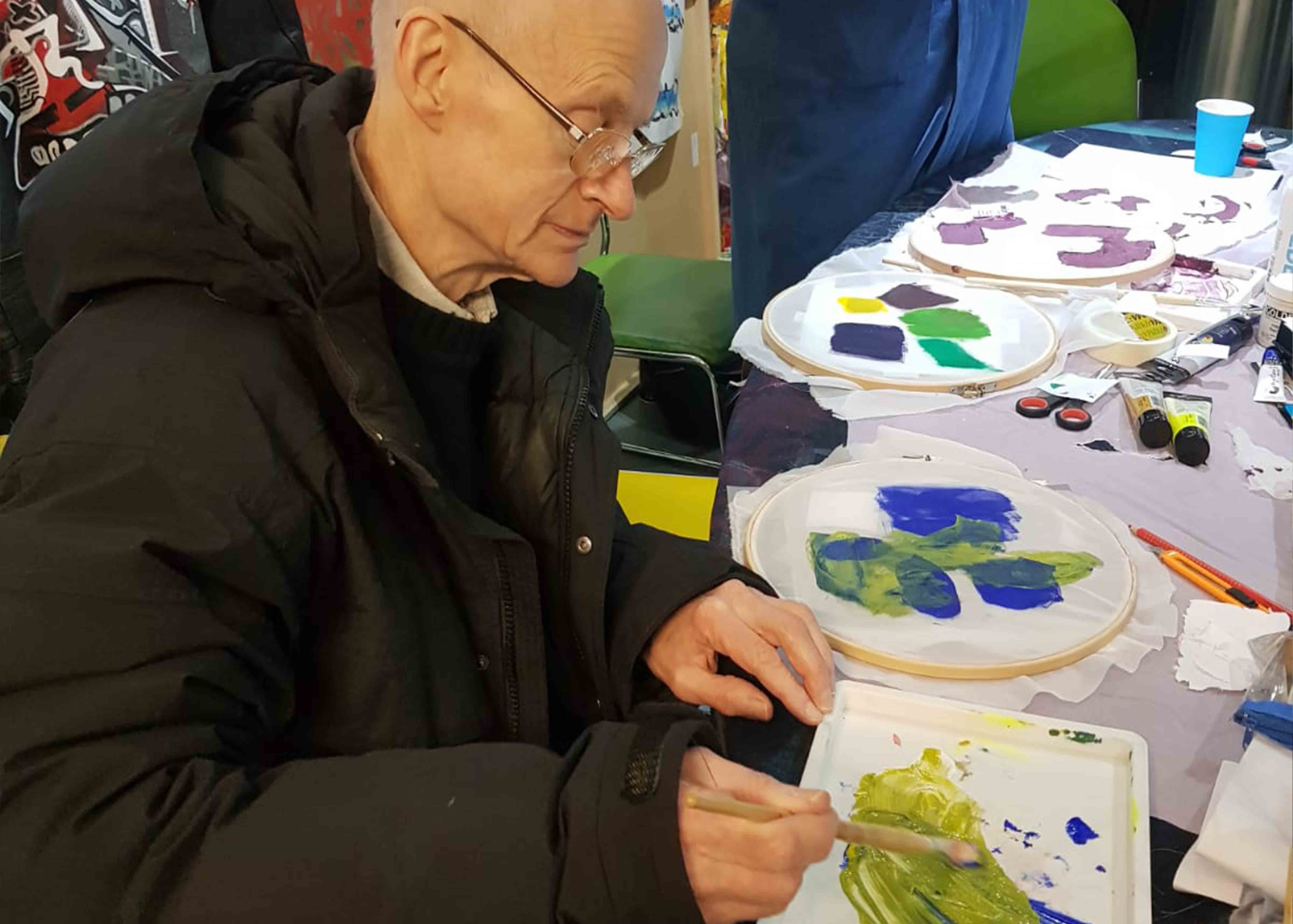 Man painting onto silk