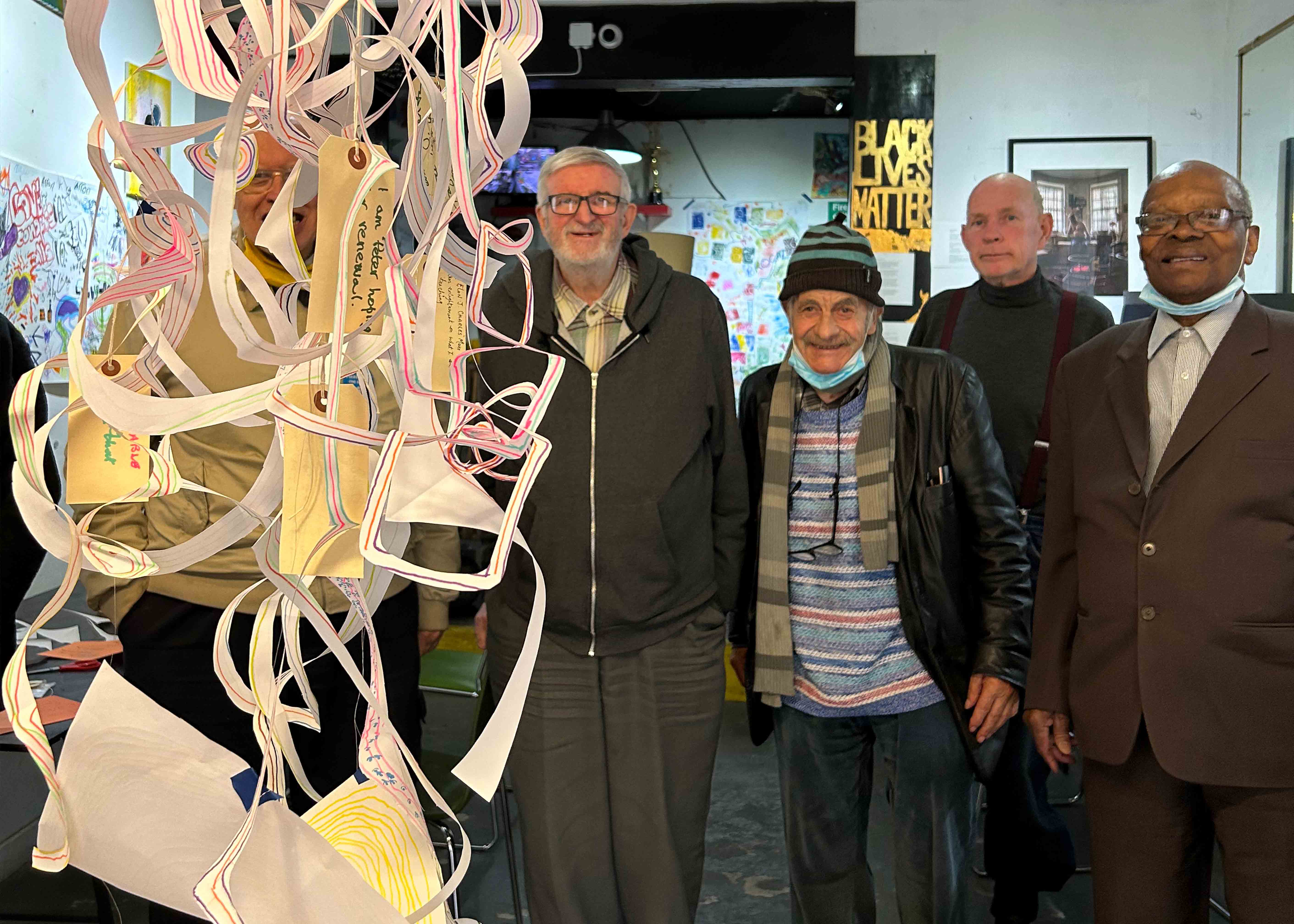 Men with a paper sculpture